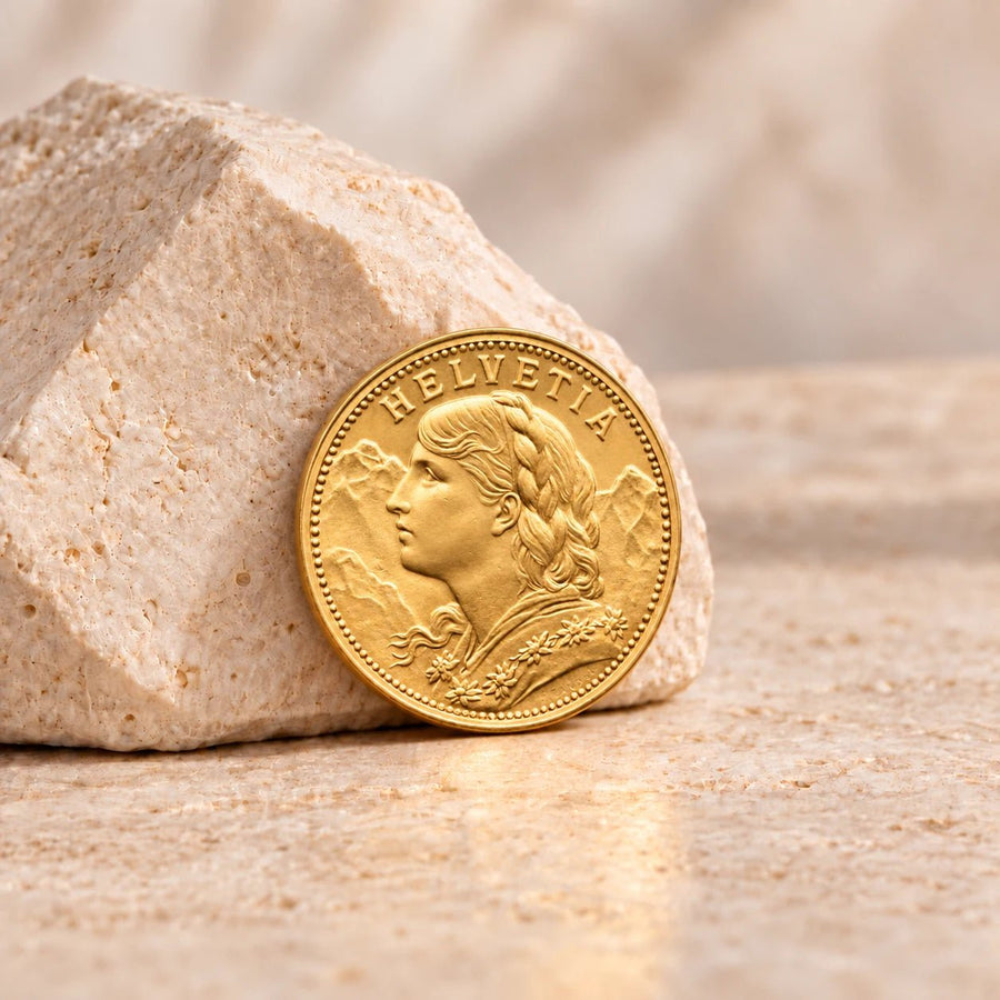 Moeda suíça Vreneli de 20 francos em ouro 900 milésimas, de desenho numismático tradicional.